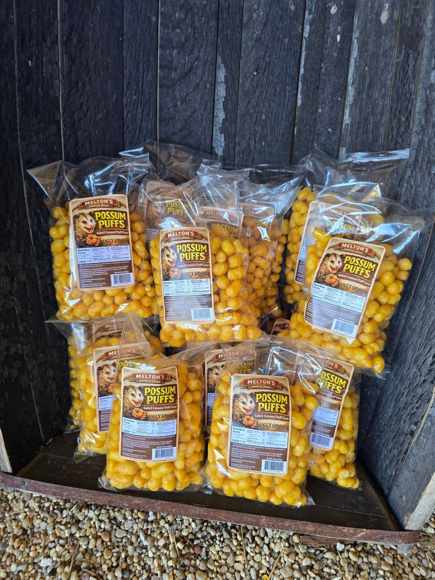 Bags of Possum Puffs — Snickerdoodle and Salted Caramel puff corn stacked at the farm stand