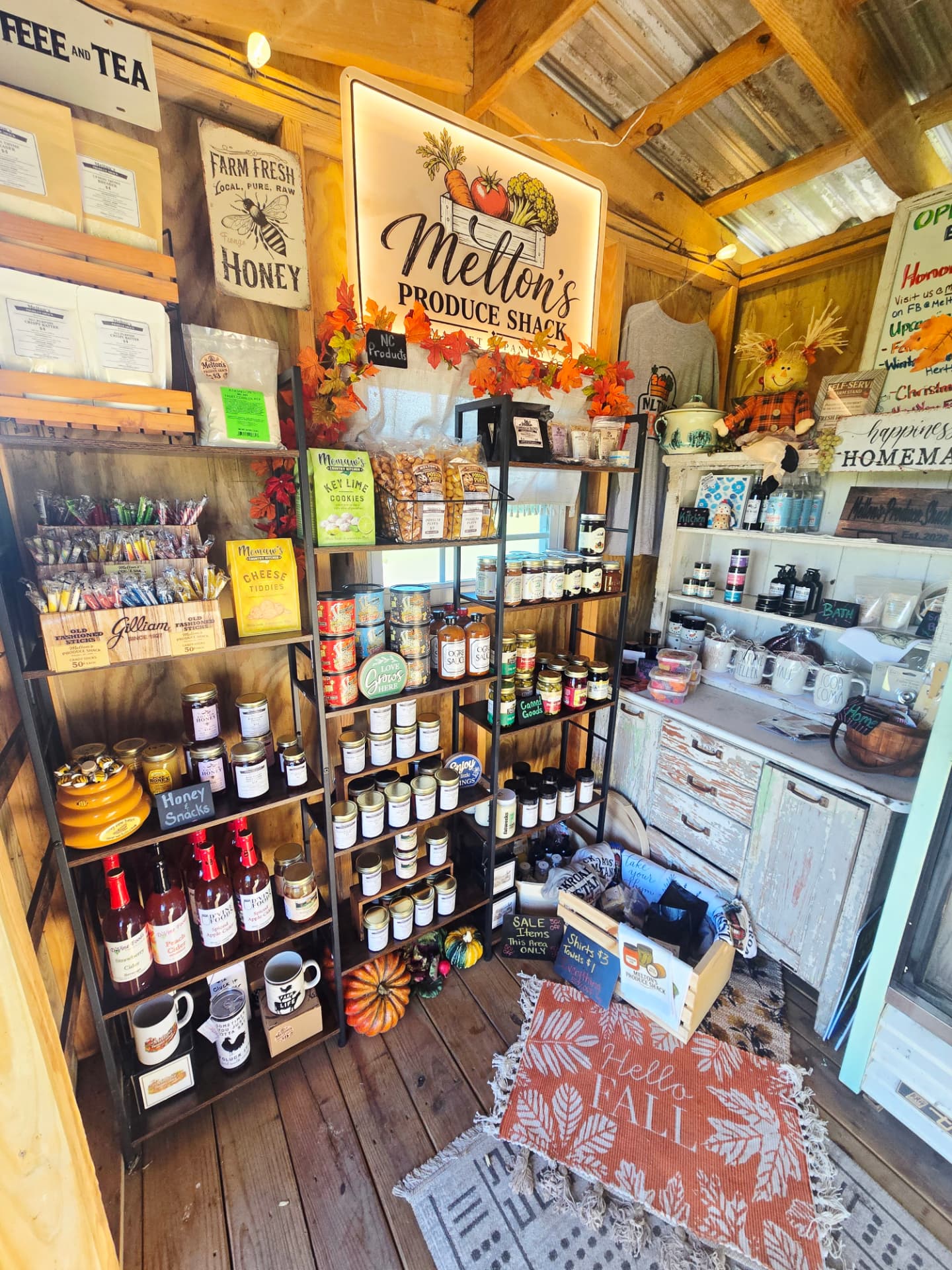 Shelves of pantry goods, honey, candles and Possum Puffs inside the shack
